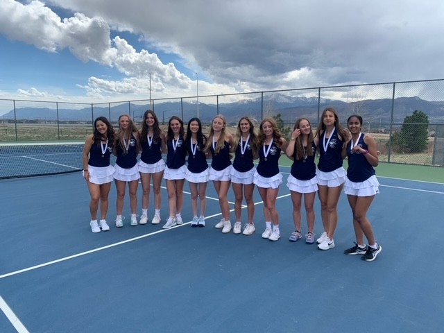 The PCHS Girls Tennis team poses on the court.